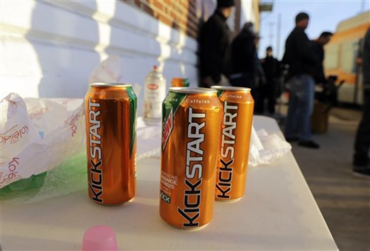 Product cans are on display during the filming of a commercial for a new PepsiCo product called Kickstart, a carbonated drink that is part juice with Mountain Dew flavor, on the streets of downtown Los Angeles Tuesday, Jan. 29, 2013. 